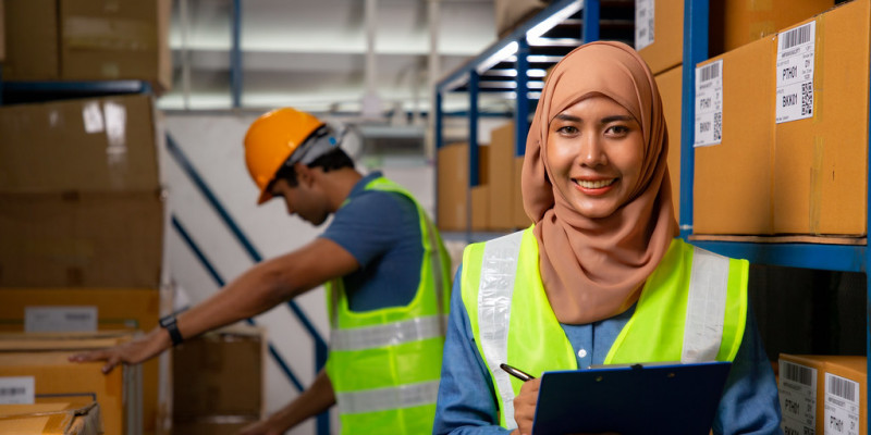 Employee with clipboard and high vis vest